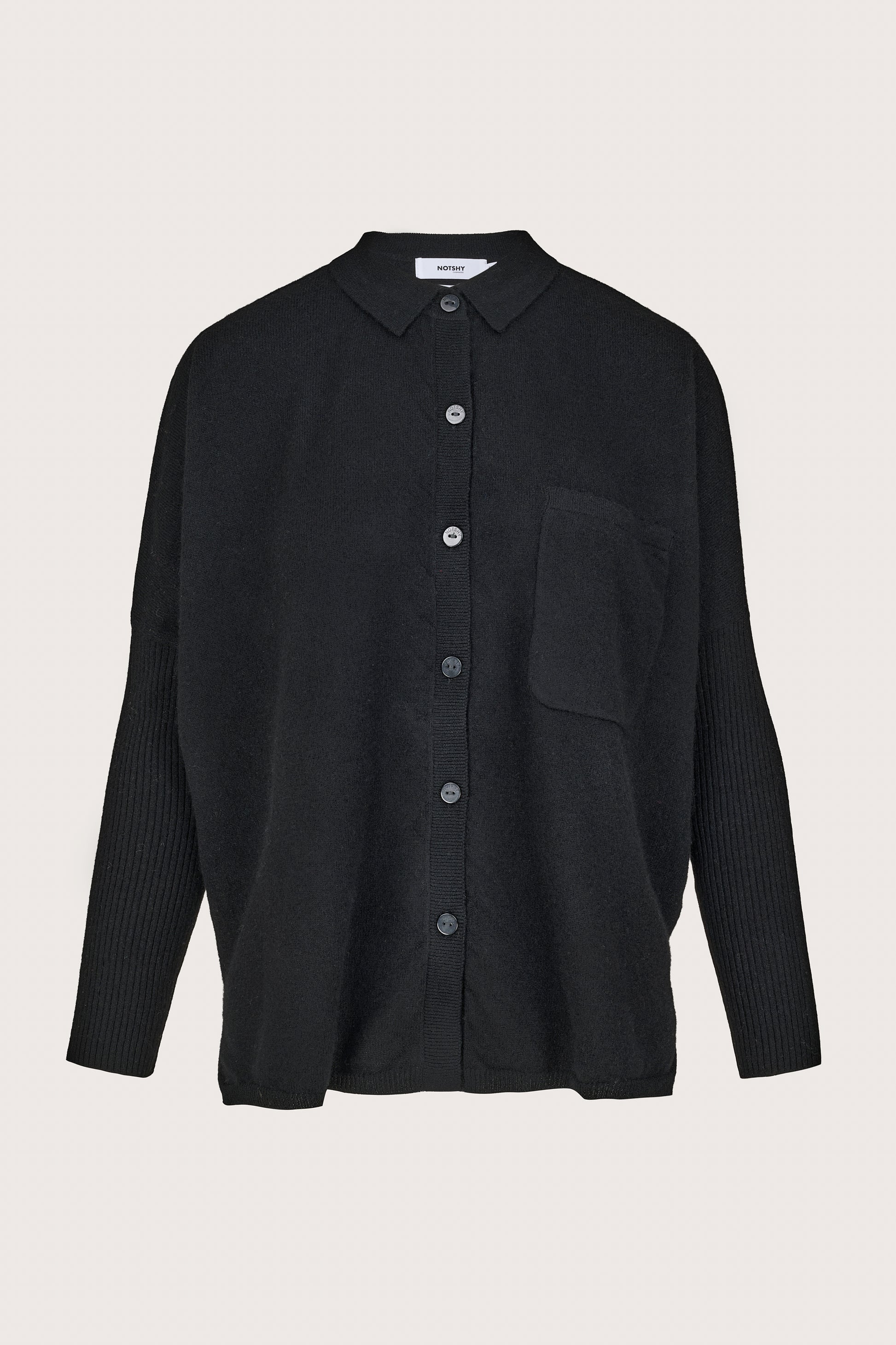 Black cashmere shirt with buttons on a light gray background