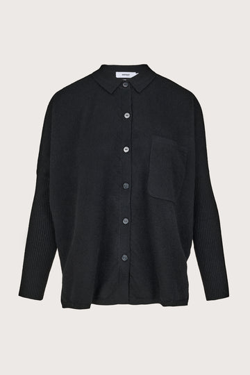 Black cashmere shirt with buttons on a light gray background