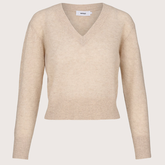 Lightweight cashmere Beige sweater on a light beige background