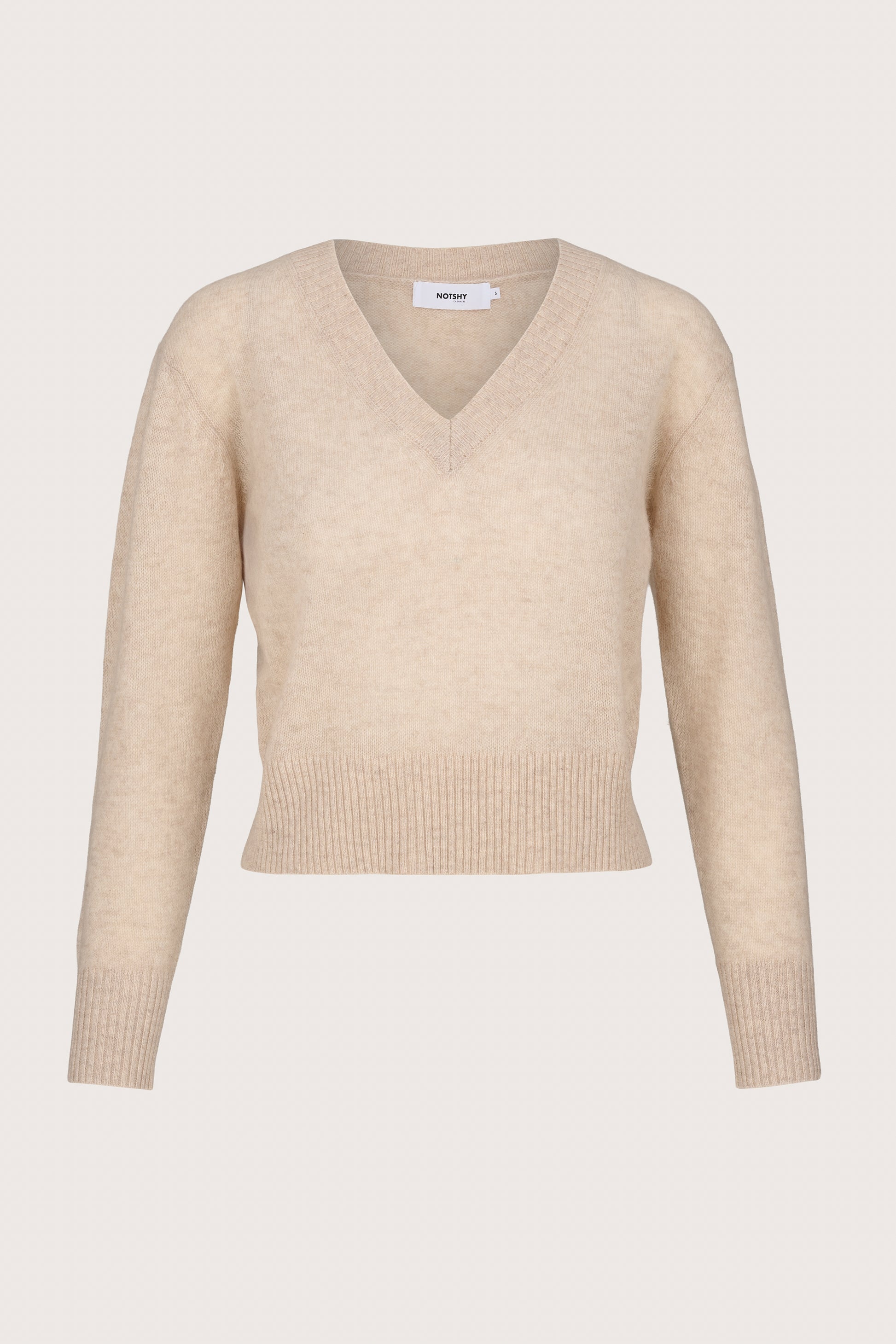Lightweight cashmere Beige sweater on a light beige background
