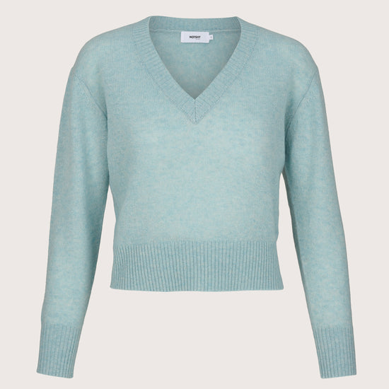 Light blue sweater on a light gray background