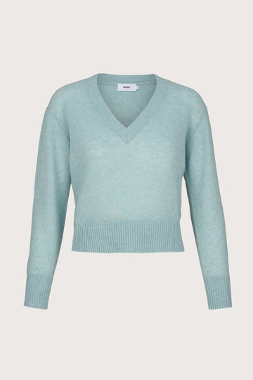 Light blue sweater on a light gray background
