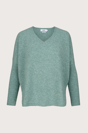 Green cashmere sweater on a light gray background