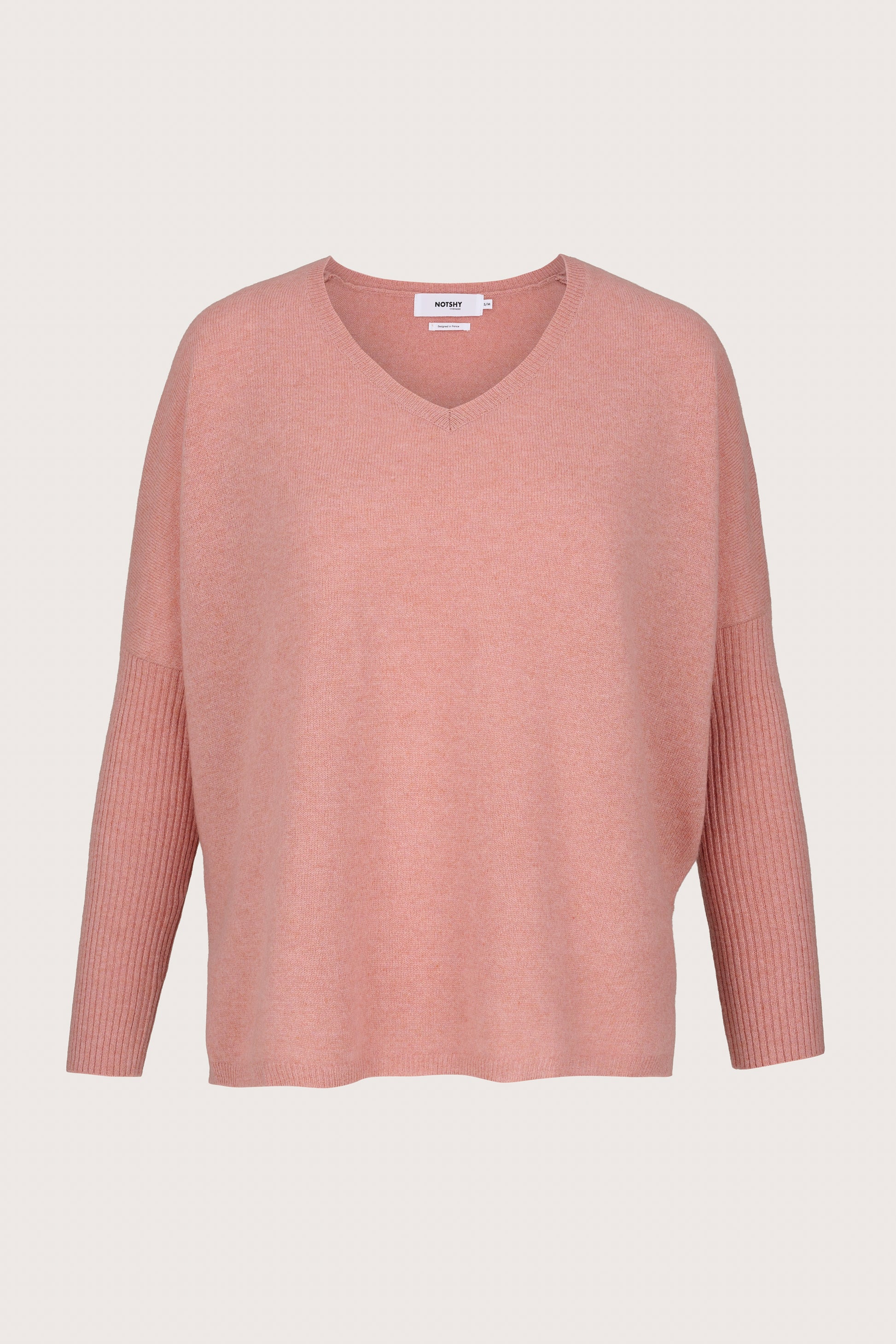 Cashmere Pink sweater on a light beige background