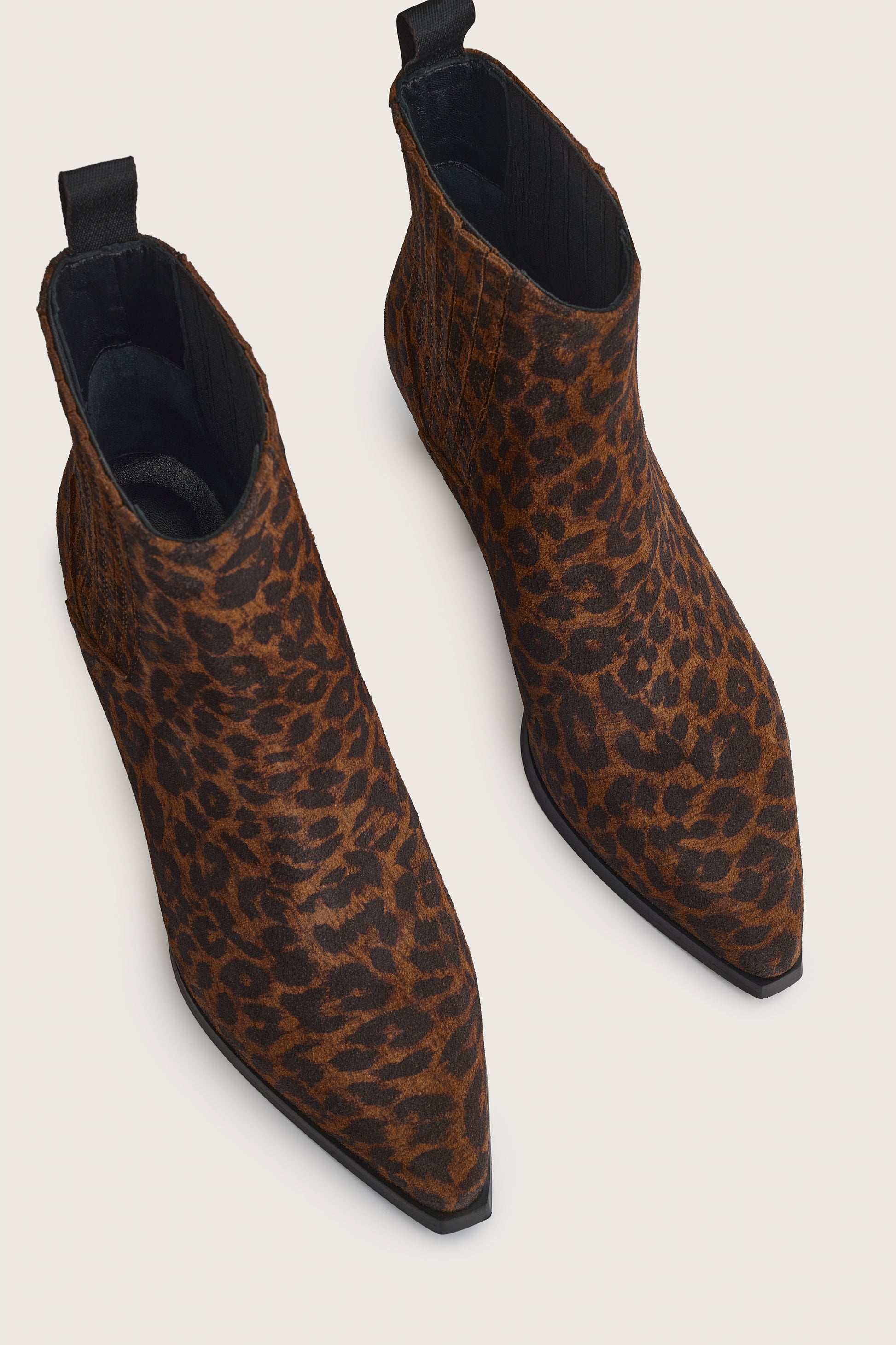 Leopard print ankle boots on a light gray background