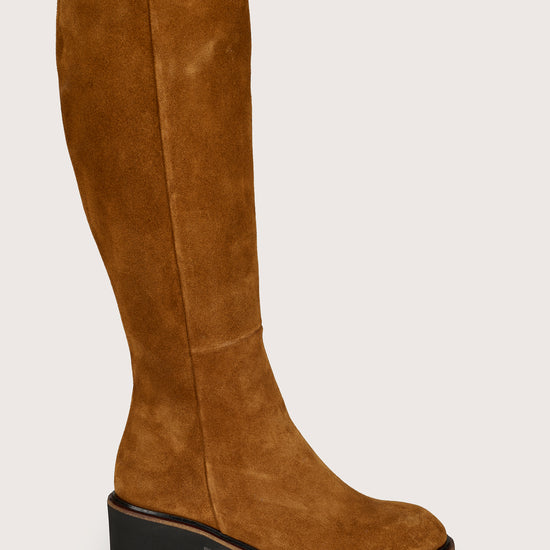 Tan knee-high boot on a light gray background