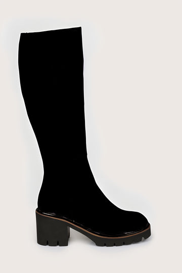 Black knee-high boot on a light gray background