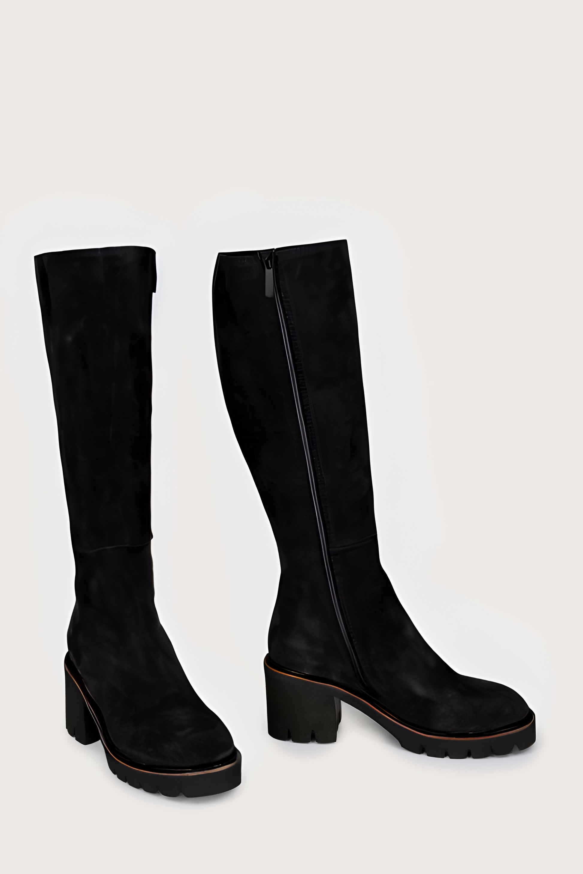 Pair of black knee-high boots on a light gray background