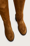 Tan suede knee-high boots on a light gray background