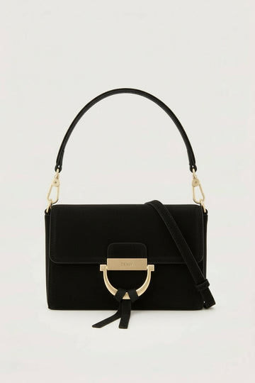 Black handbag with gold accents on a light gray background
