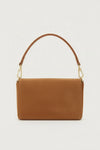 tan suede handbag with a gold clasp on a light gray background