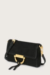 Black handbag with gold accents on a light gray background