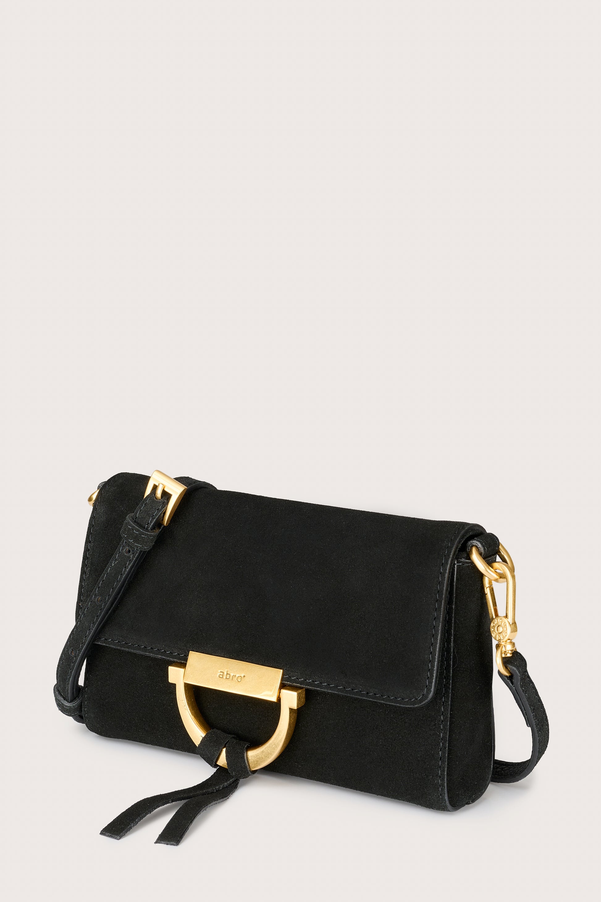 Black handbag with gold accents on a light gray background