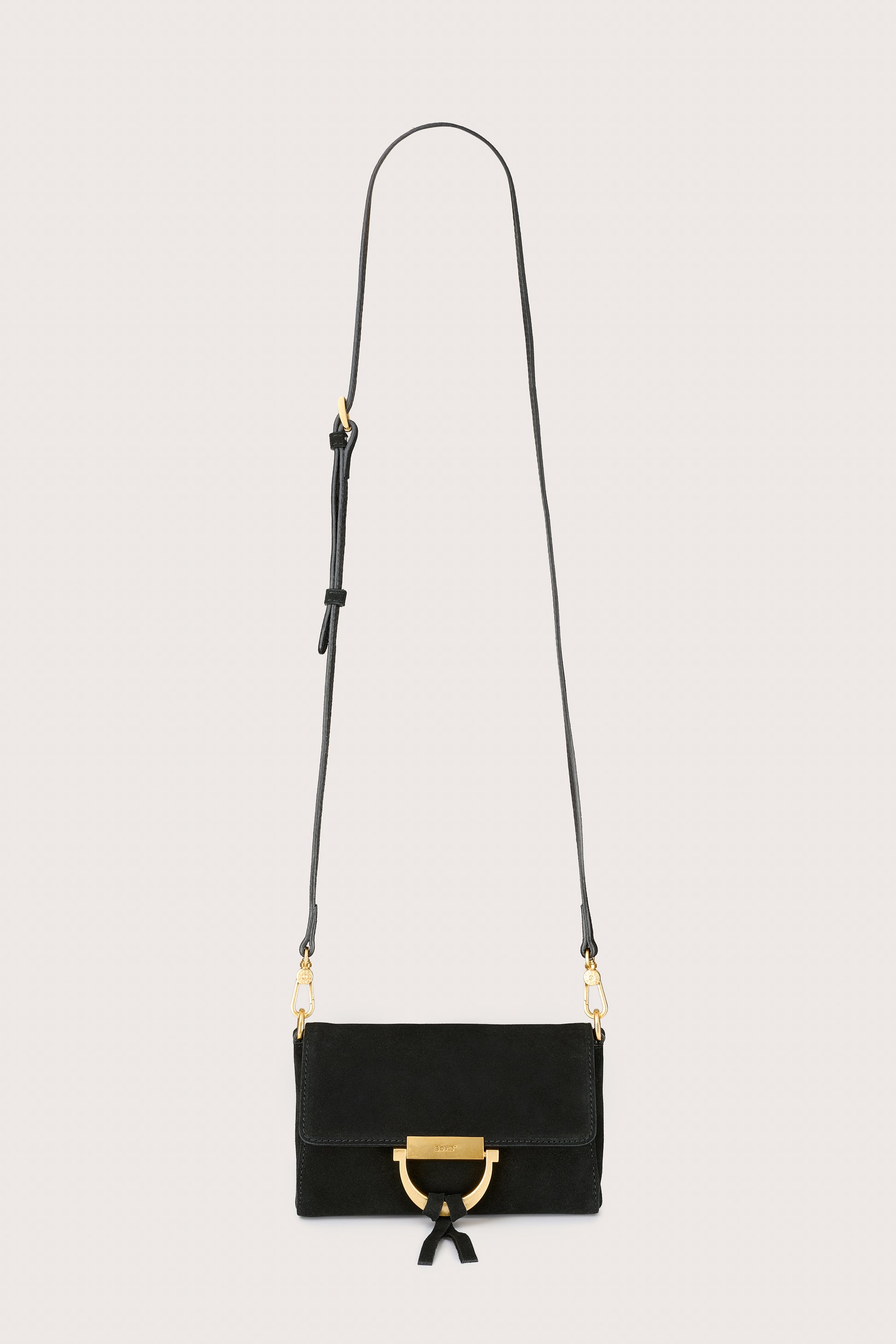 Black handbag with gold accents on a light gray background