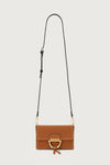 Tan suede handbag with a gold clasp on a light gray background