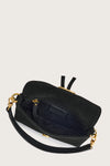 Black handbag with gold accents on a light gray background inside view