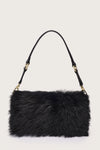 Black fur handbag with gold accents on a light gray background