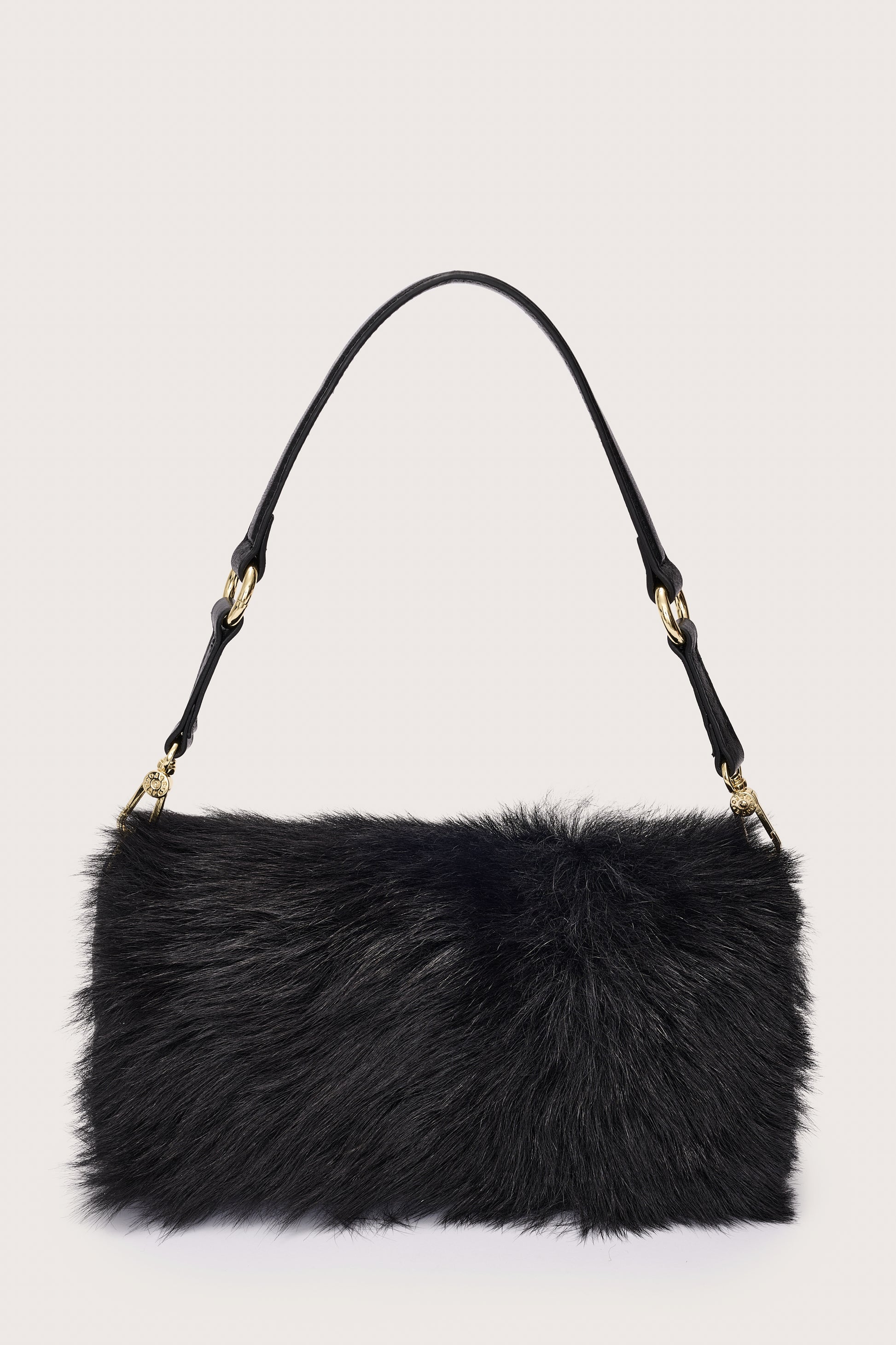 Black fur handbag with gold accents on a light gray background