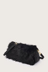 Black fur bag with gold accents on a light gray background