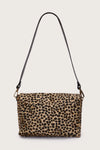 Leopard print handbag with a black strap on a light gray background rear view