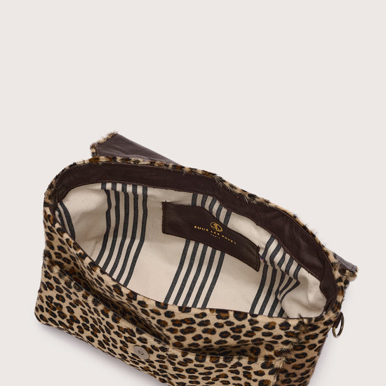 Leopard print pouch with striped lining on a light background interior shot