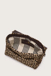 Leopard print pouch with striped lining on a light background interior shot