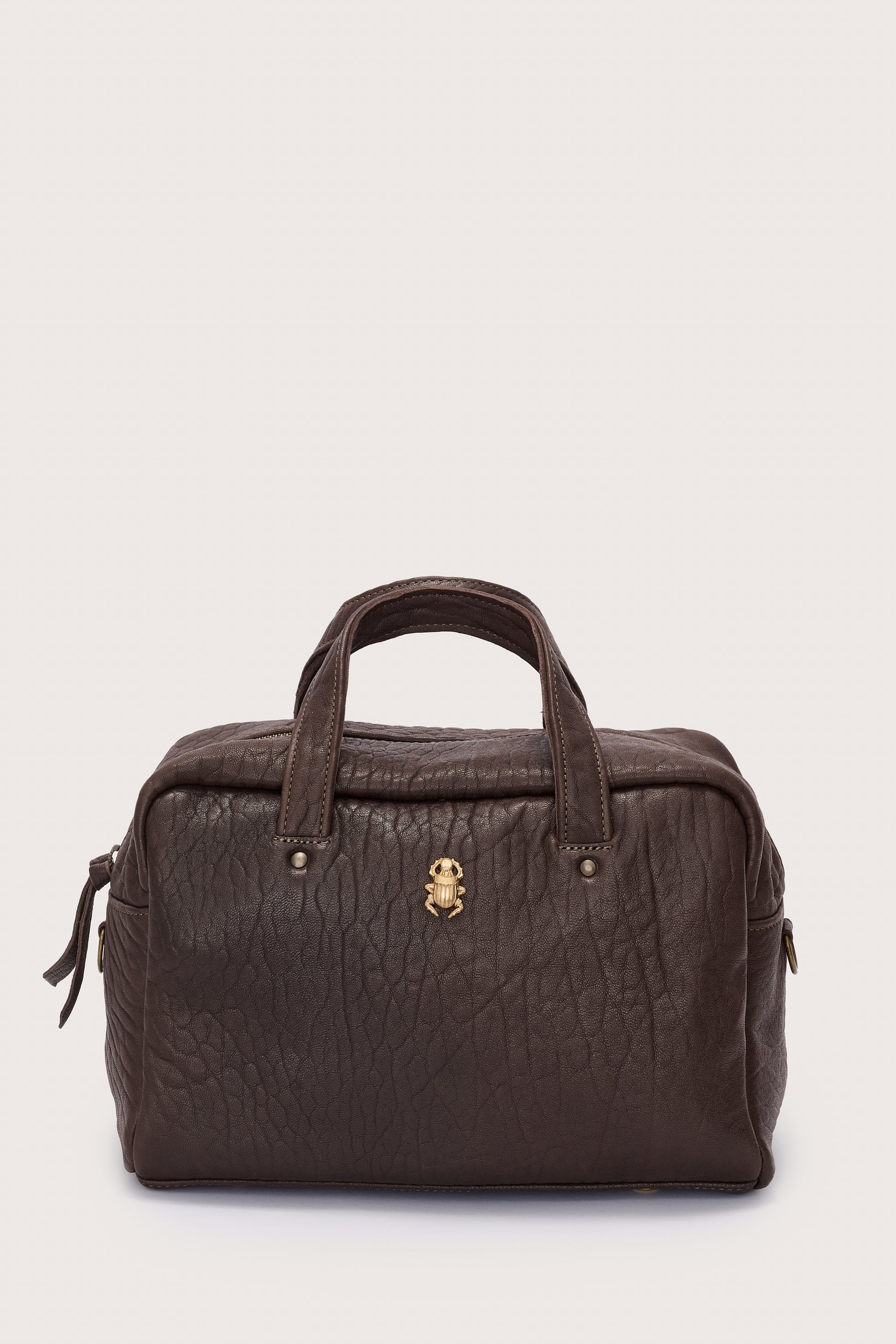 Brown leather bag with a gold clasp on a light gray background