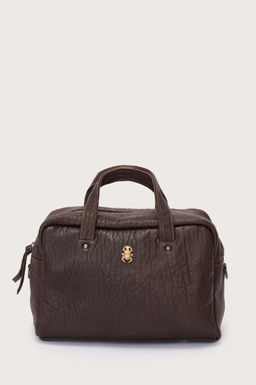 Brown leather bag with a gold clasp on a light gray background