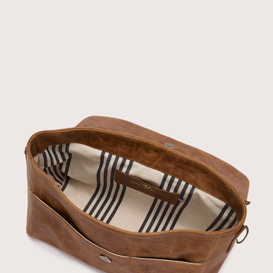 caramel leather flap bag with chain strap and panther stamp inside view