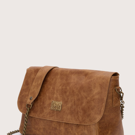 caramel leather flap bag with chain strap and panther stamp side view