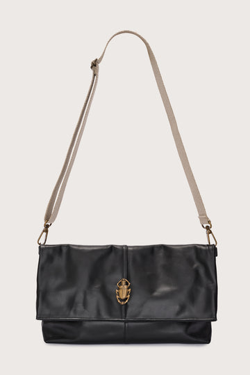 black leather fold over bag with gold scarab stamp and linen strap