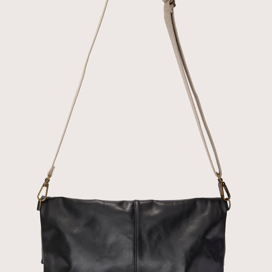 black leather fold over bag with gold scarab stamp and linen strap rear view