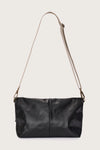 black leather fold over bag with gold scarab stamp and linen strap rear view