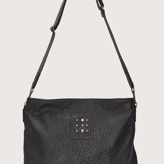 black leather bag with black linen strap and metal stamp detailing