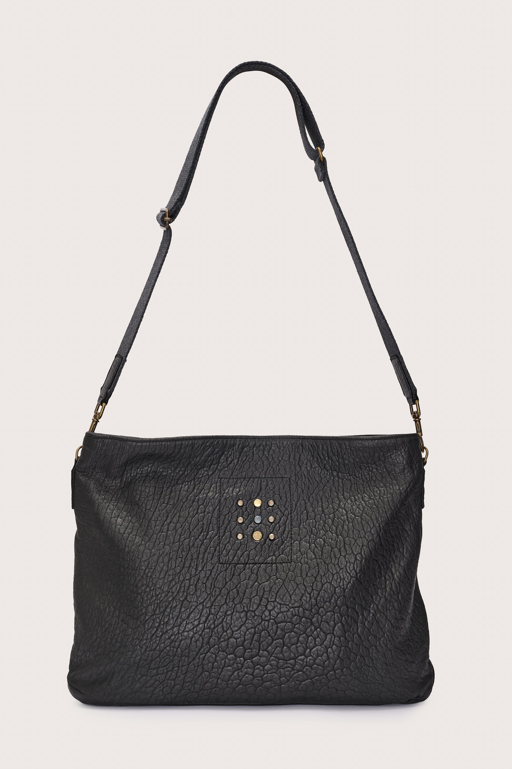 black leather bag with black linen strap and metal stamp detailing