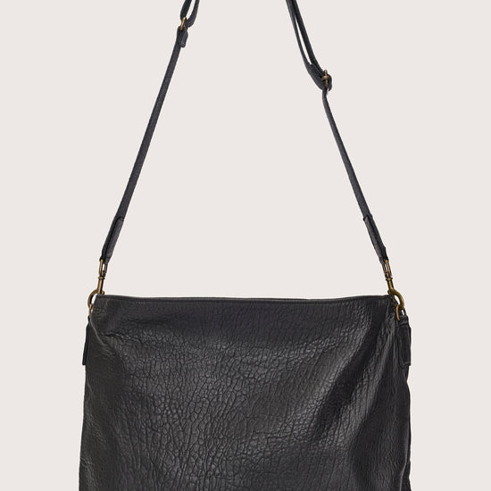 black leather bag with black linen strap and metal stamp detailing rear view