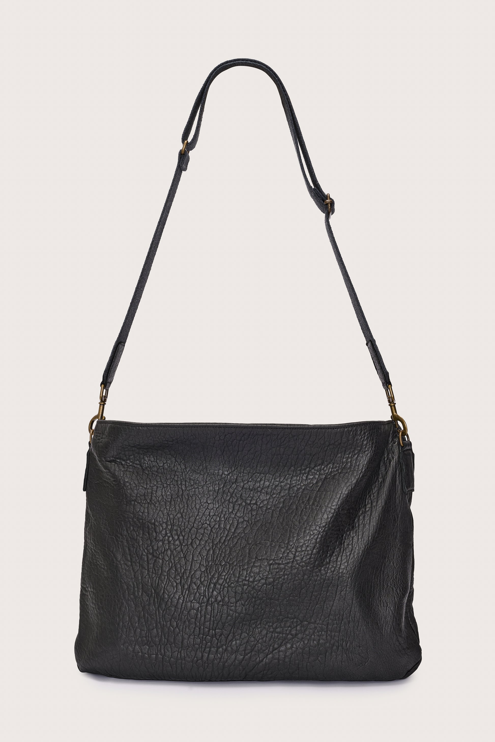 black leather bag with black linen strap and metal stamp detailing rear view
