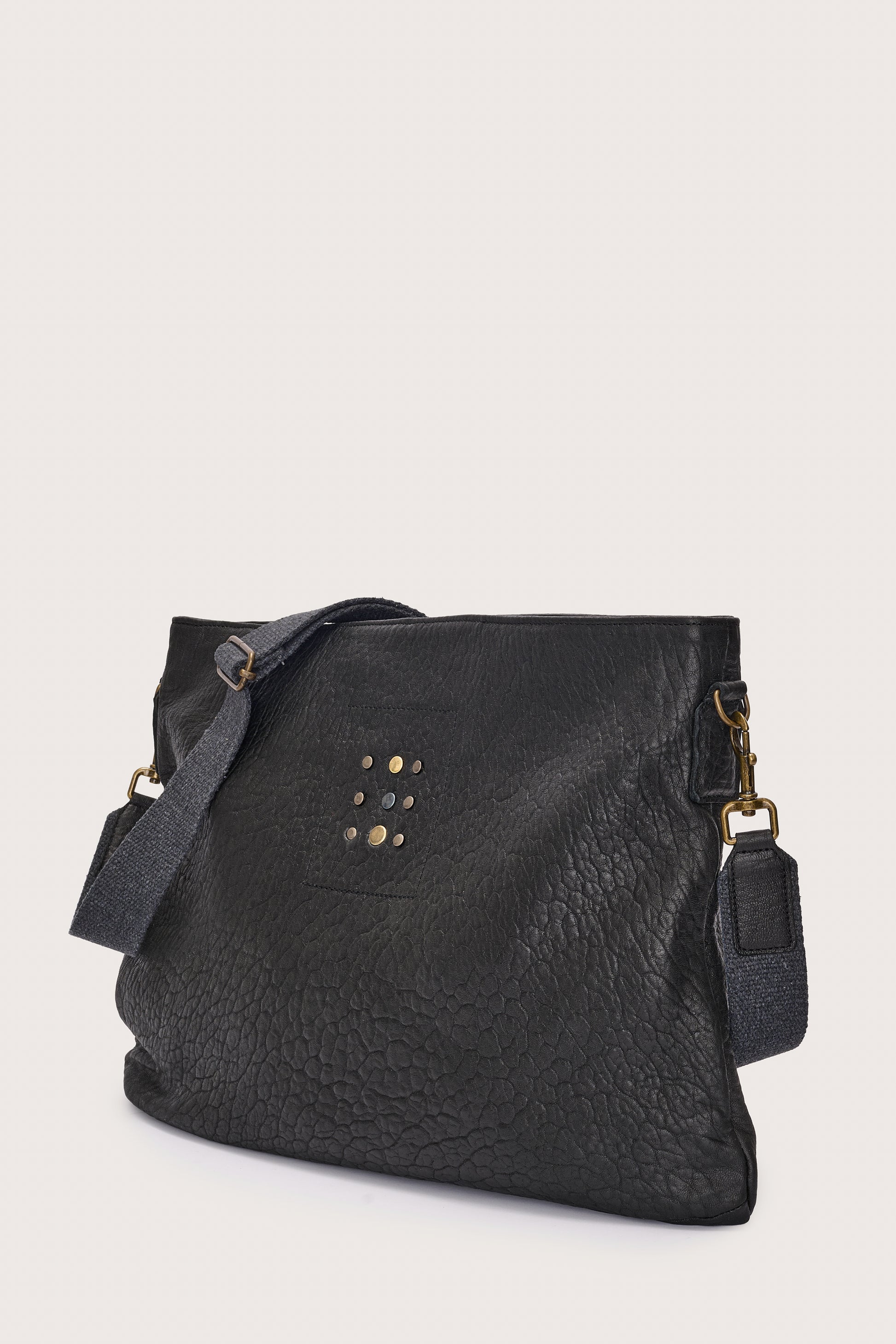 black leather bag with black linen strap and metal stamp detailing side view