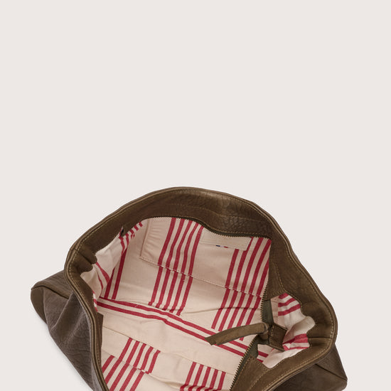 khaki green leather bag with khaki green linen strap and metal stamp detailing inside view