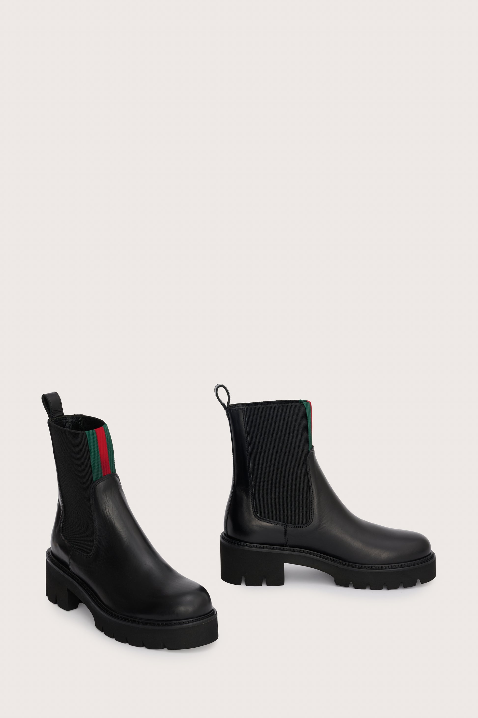 chunky black ankle boots with elasticated panels on side and red/green stripe on the front side view