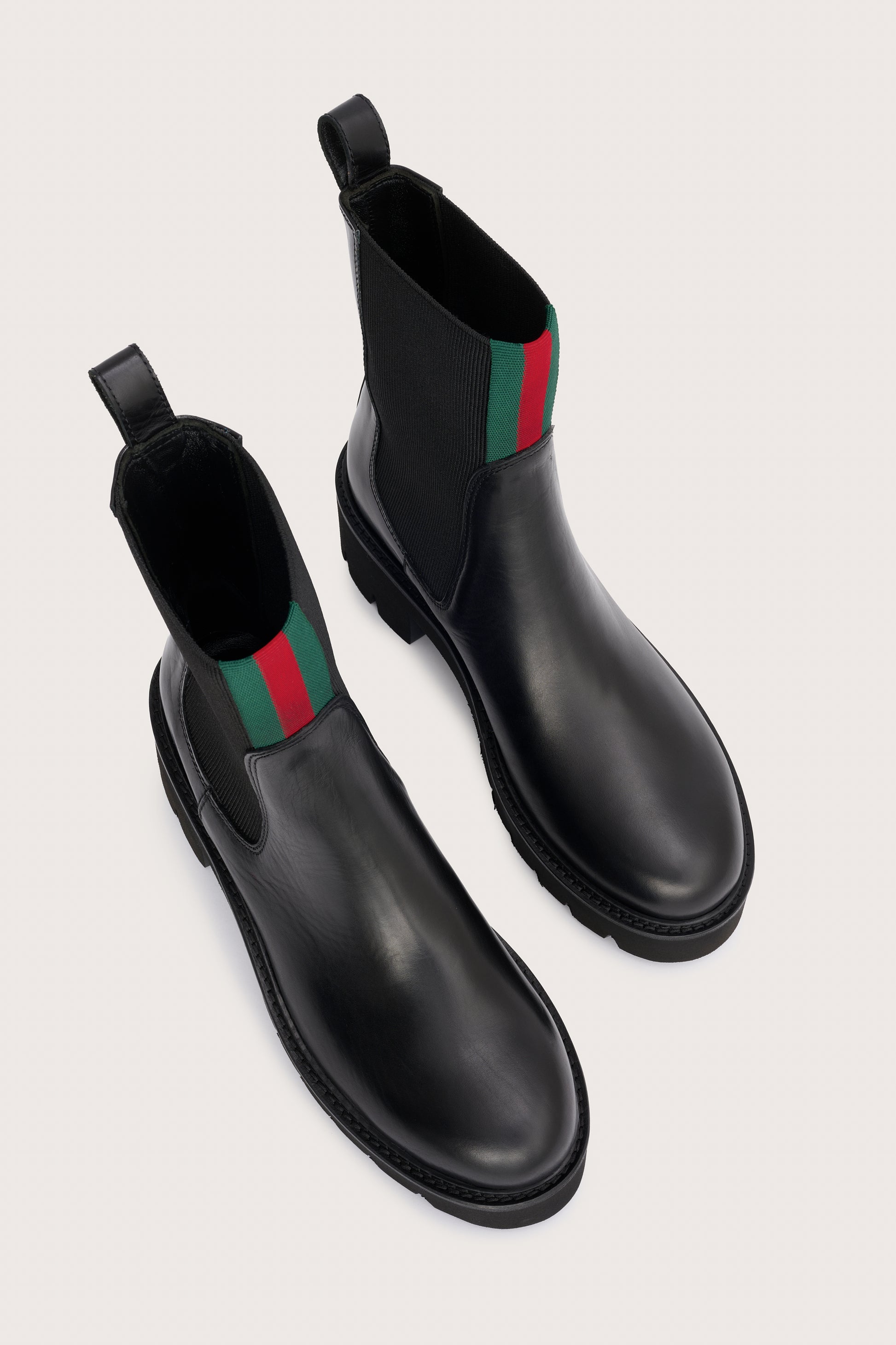 chunky black ankle boots with elasticated panels on side and red/green stripe on the front birds eye view