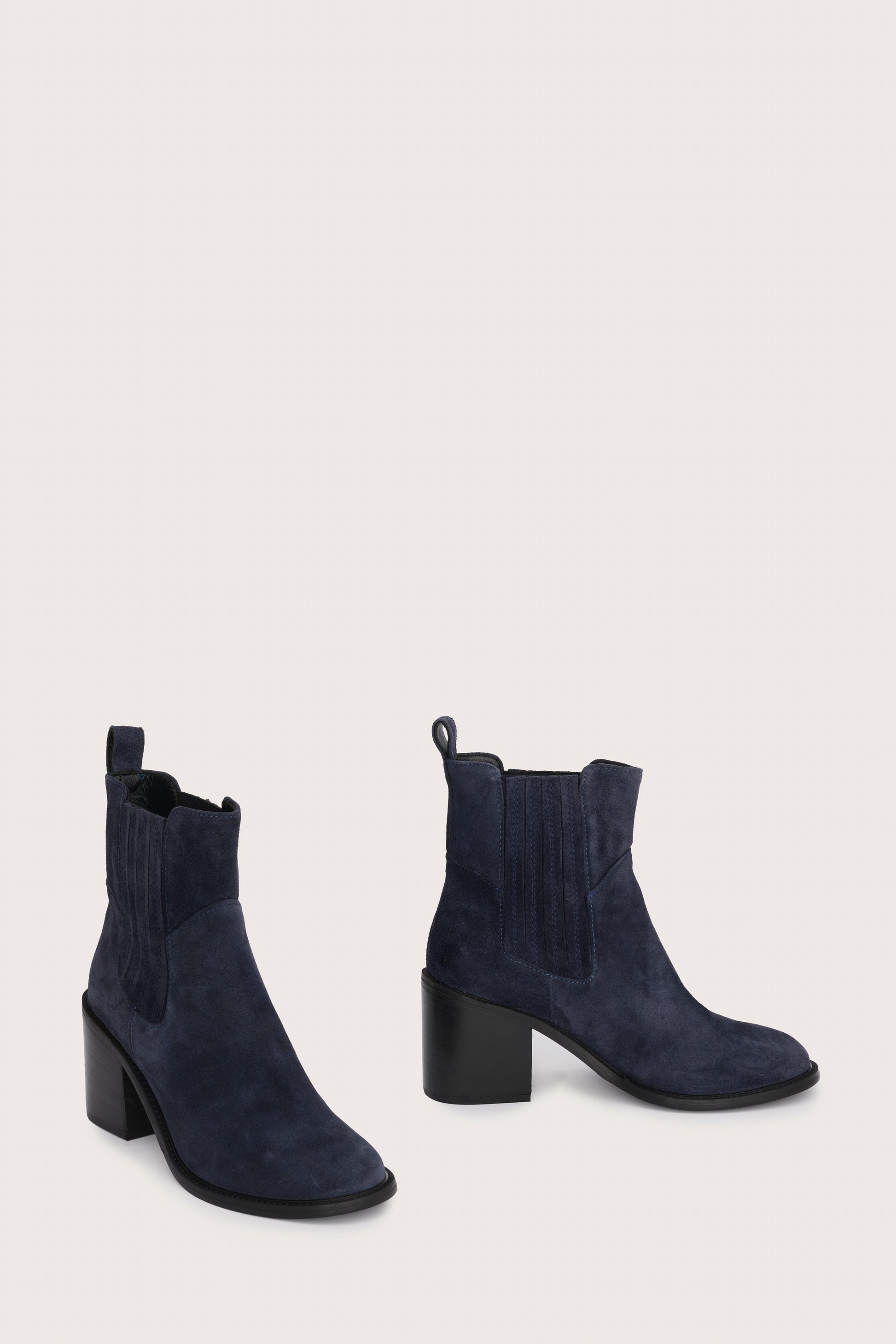 navy blue suede ankle boots with chunky black heel and elasticated tabs either side side view 