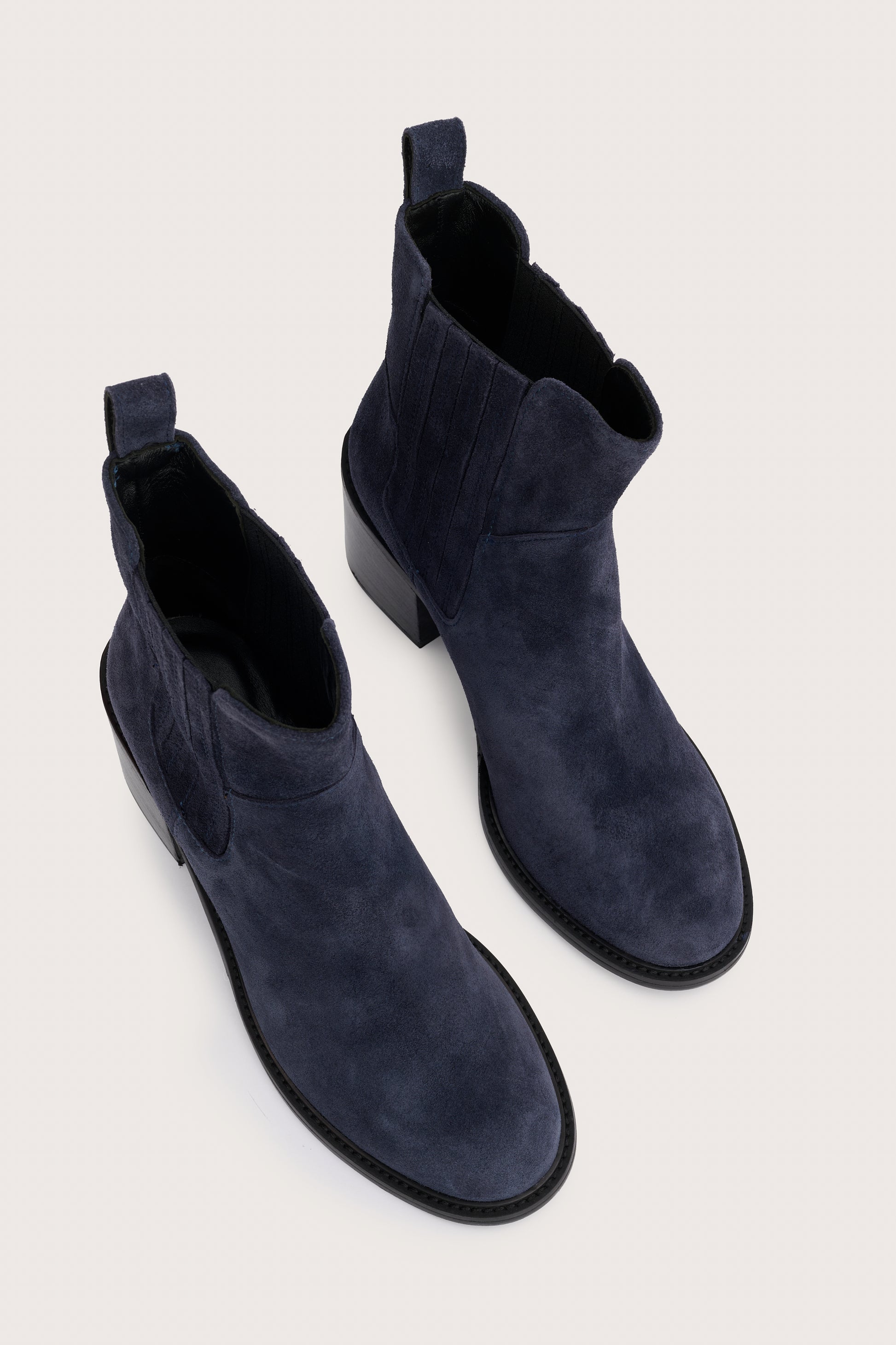 navy blue suede ankle boots with chunky black heel and elasticated tabs either side birds eye view