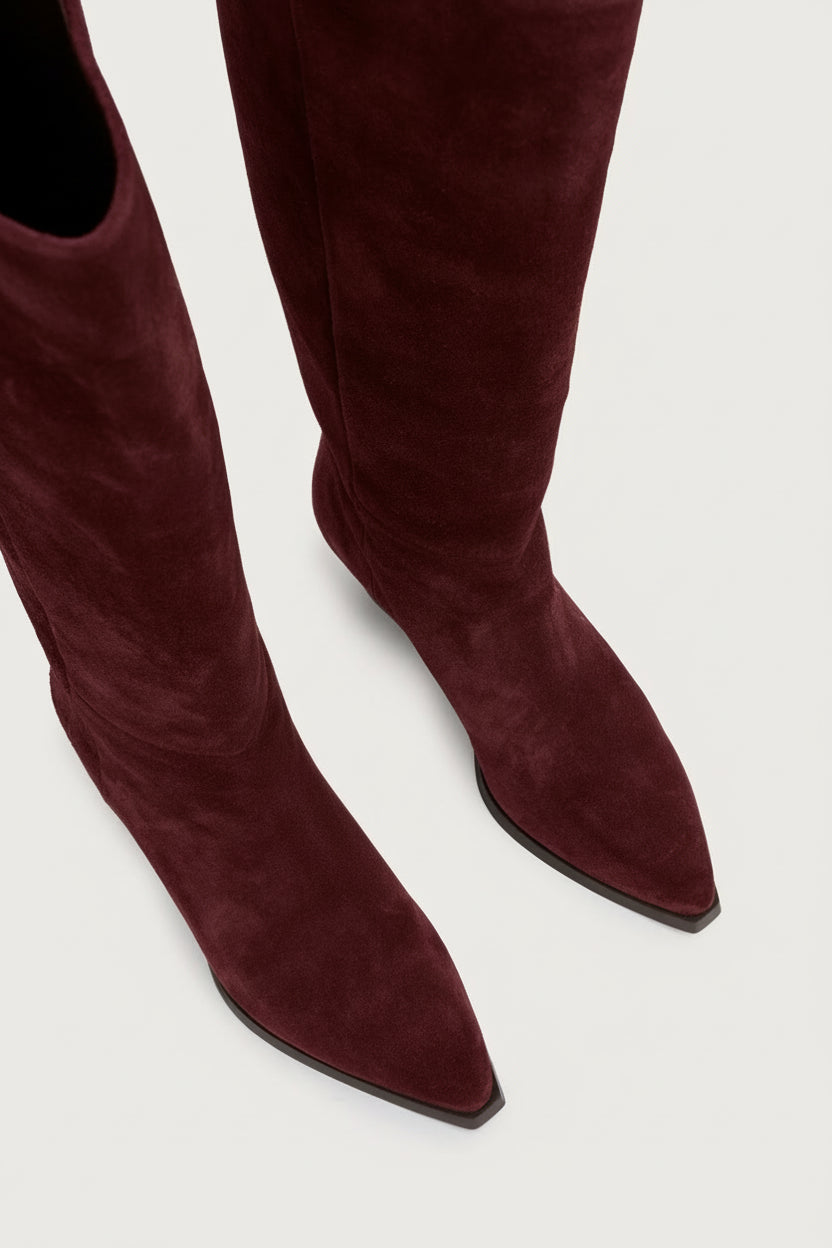 Bordeaux suede knee-high boots on a white background