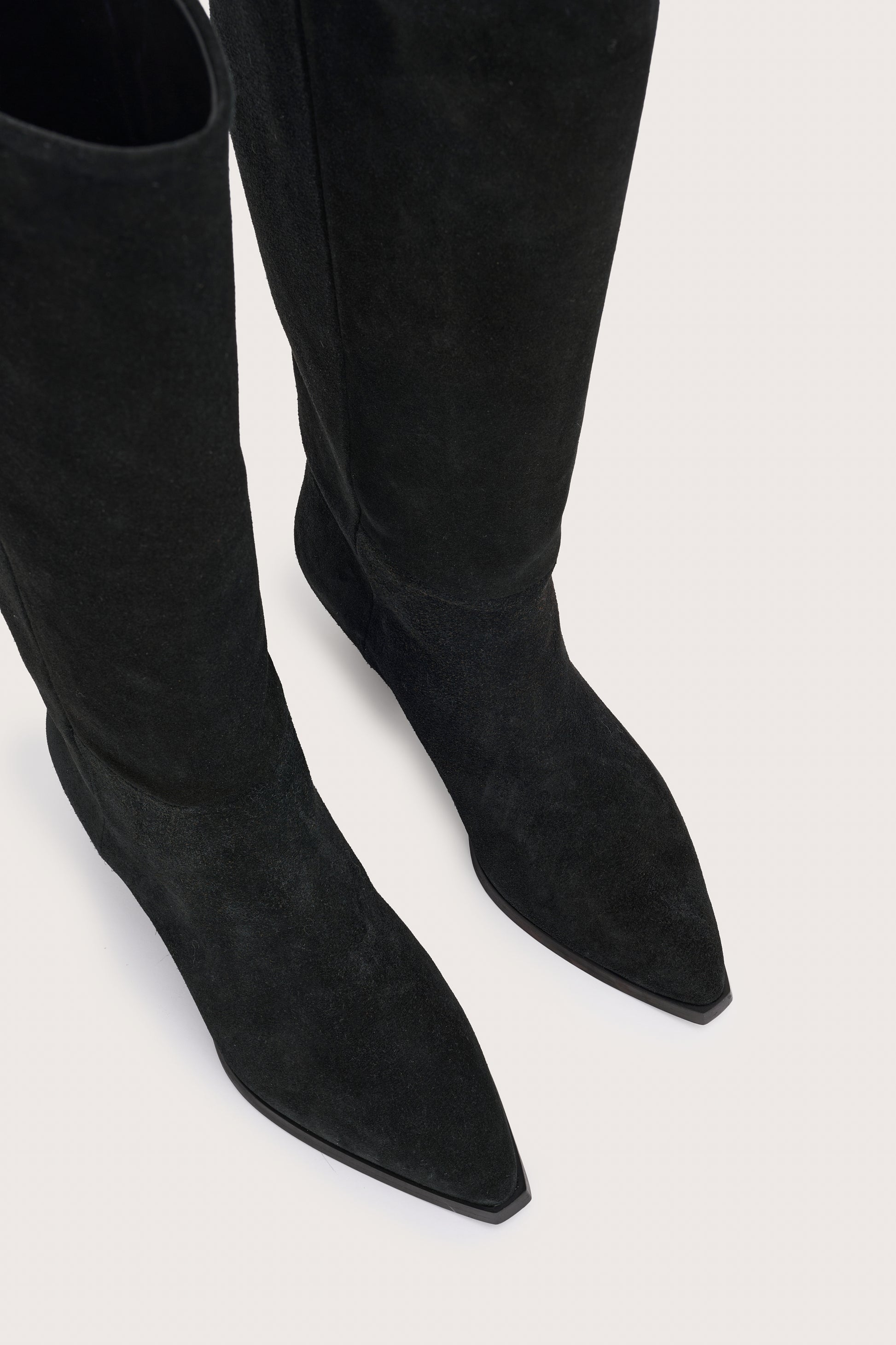 black suede cowboy boots with black heel birds eye view