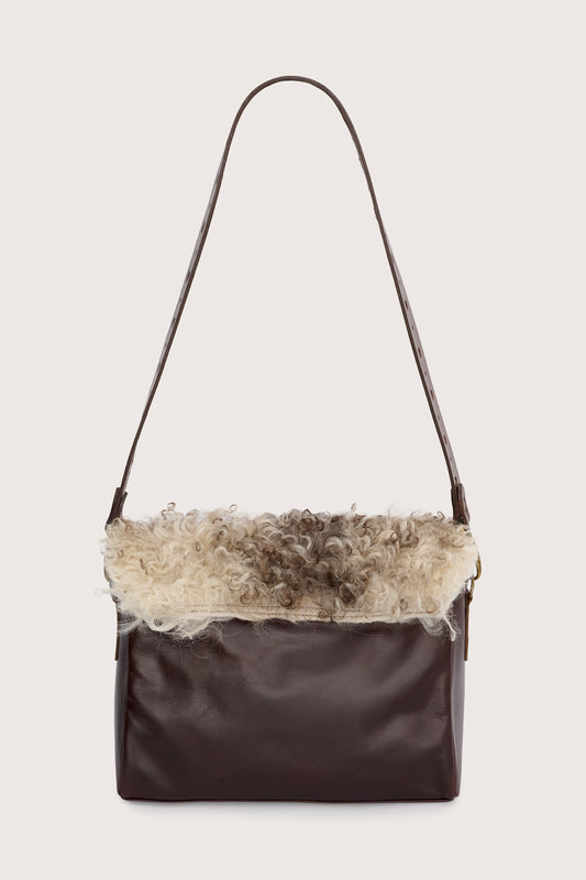 chocolate brown leather cross body bag with short curly hair on the front and a gold panther stamp from sous les paves rear view