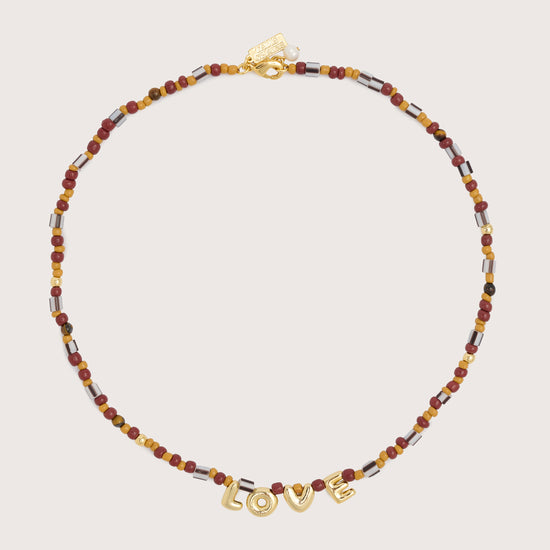 brown multi beaded choker necklace with gold love charms in the centre