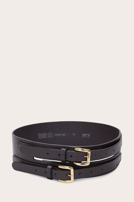 Two black leather belts with gold-tone buckles, stacked and photographed on a light beige background. The inner belt shows the brand name 'abro'.