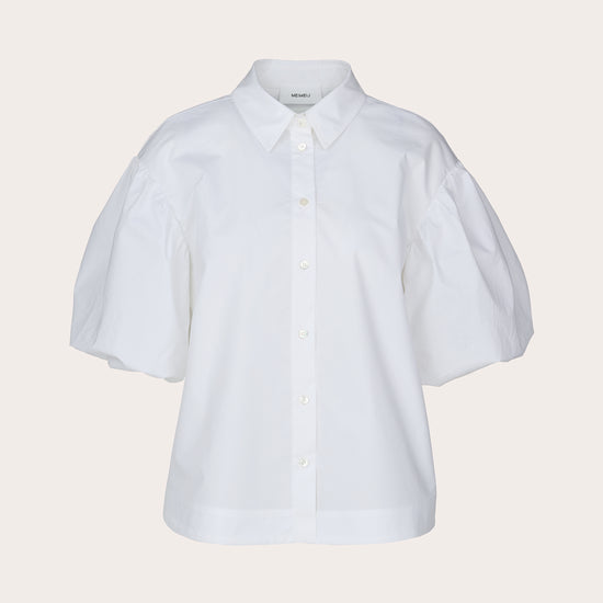 A white short-sleeve button-up shirt with voluminous puff sleeves, a pointed collar, and decorative buttons, shown against a solid light beige background.