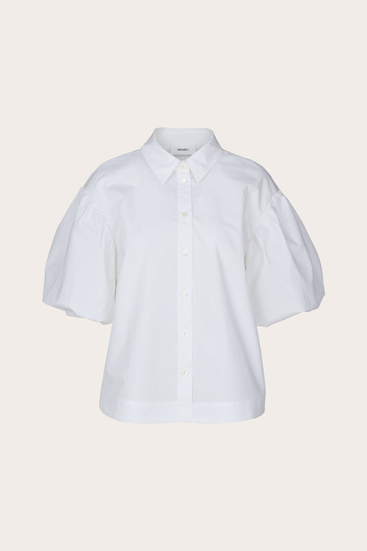 A white short-sleeve button-up shirt with voluminous puff sleeves, a pointed collar, and decorative buttons, shown against a solid light beige background.